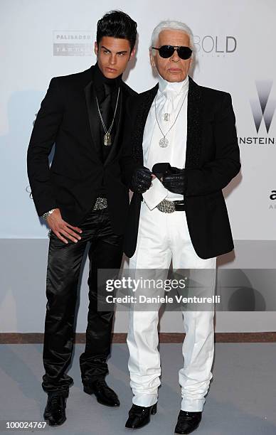 Baptiste Giabiconi and Karl Lagerfeld arrive at amfAR's Cinema Against AIDS 2010 benefit gala at the Hotel du Cap on May 20, 2010 in Antibes, France.