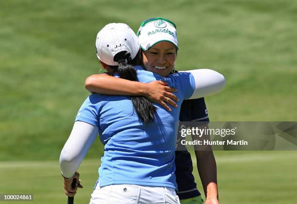 Ai Miyazato of Japan hugs Jeong Jang of South Korea after finishing their match on the 15th hole during the first round of the Sybase Match Play...