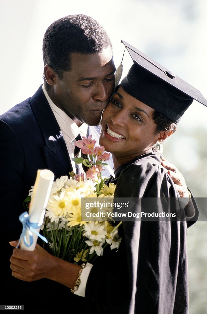 BLACK COUPLE AT WOMAN'S GRADUATION