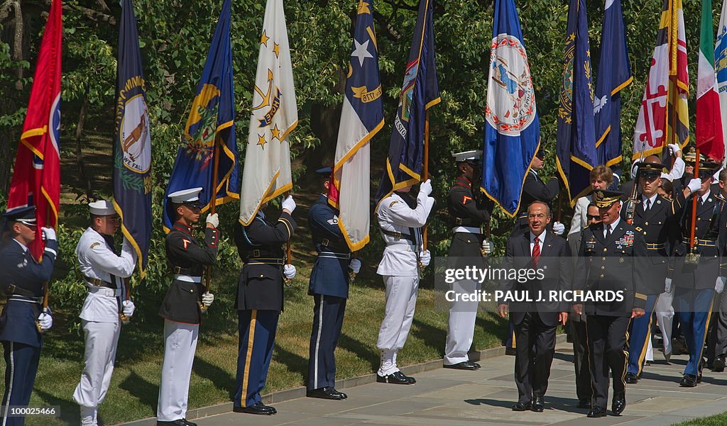 Members of the US Honor Guard hold flags