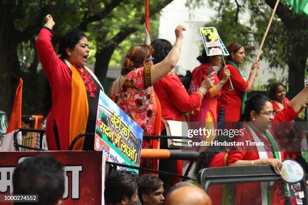 All India Mahila Congress workers raise slogans as they take out a jeep rally to protest against the centre over the passage of Women's Reservation...