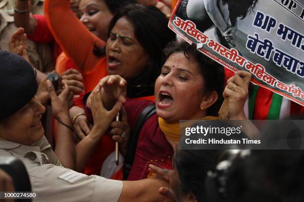 All India Mahila Congress workers raise slogans as they take out a jeep rally to protest against the centre over the passage of Women's Reservation...