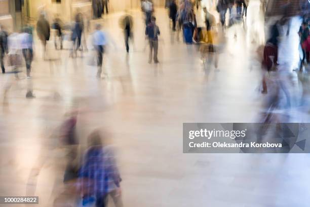 fast moving crowd of commuters at grand central station in new york. motion blur of figures headed to their jobs. - fast motion stock pictures, royalty-free photos & images