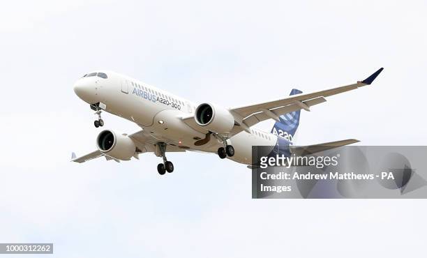An Airbus A220-300 gives a display during the opening day of the Farnborough International Airshow in Hampshire.
