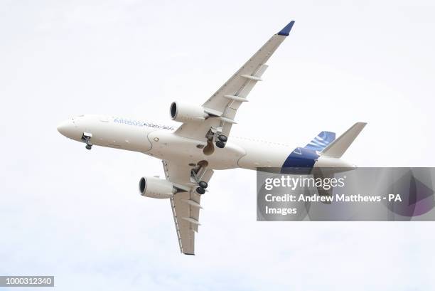 An Airbus A220-300 gives a display during the opening day of the Farnborough International Airshow in Hampshire.