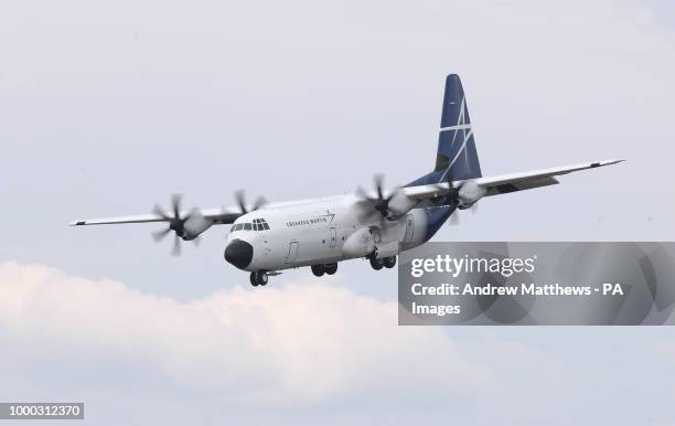 Lockhead Martin LM-100J plane gives a display during the opening day of the Farnborough International Airshow in Hampshire.