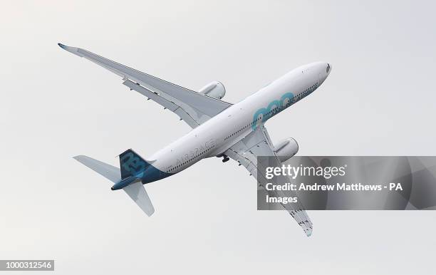 An Airbus A330-900 neo gives a display during the opening day of the Farnborough International Airshow in Hampshire.