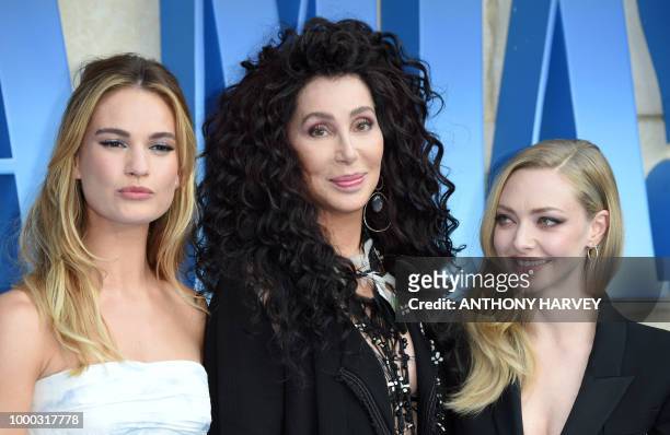 Lily James, Cher and Amanda Seyfried pose on the red carpet upon arrival for the world premiere of the film "Mamma Mia! Here We Go Again" in London...