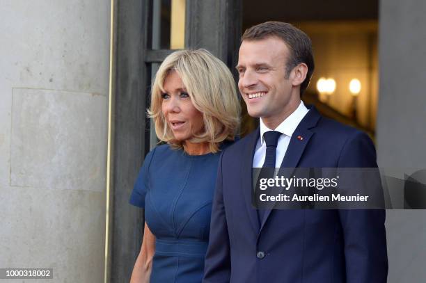 French First Lady Brigitte Macron and French President Emmanuel Macron react as French President Emmanuel Macron receives the France football team...
