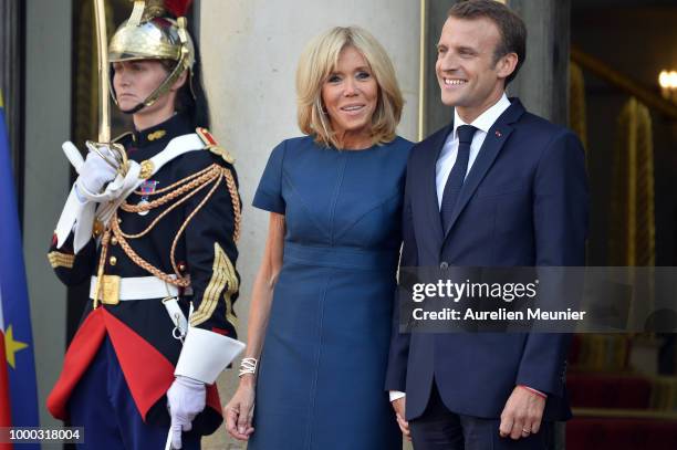 French First Lady Brigitte Macron and French President Emmanuel Macron react as French President Emmanuel Macron receives the France football team...