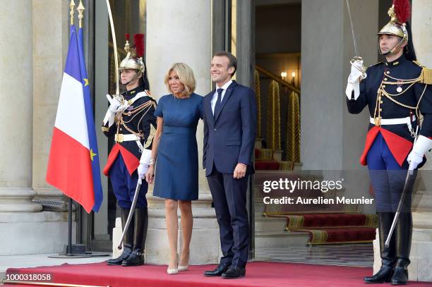 French First Lady Brigitte Macron and French President Emmanuel Macron react as French President Emmanuel Macron receives the France football team...