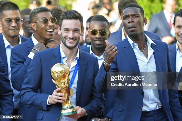 France Captain Hugo Lloris and Paul Pogba react as he holds the trophy as French President Emmanuel Macron receives the France football team during a...