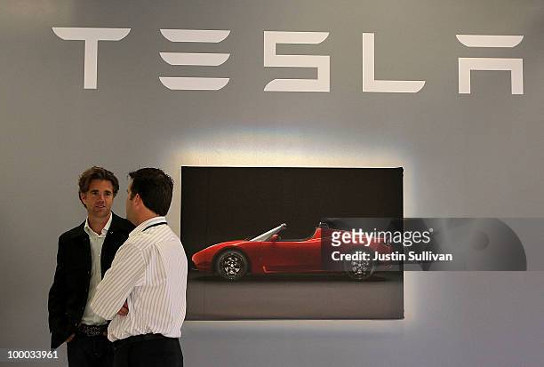 Tesla Motors workers talk before a news conference at Tesla Motors headquarters May 20, 2010 in Palo Alto, California. Electric car maker Tesla...