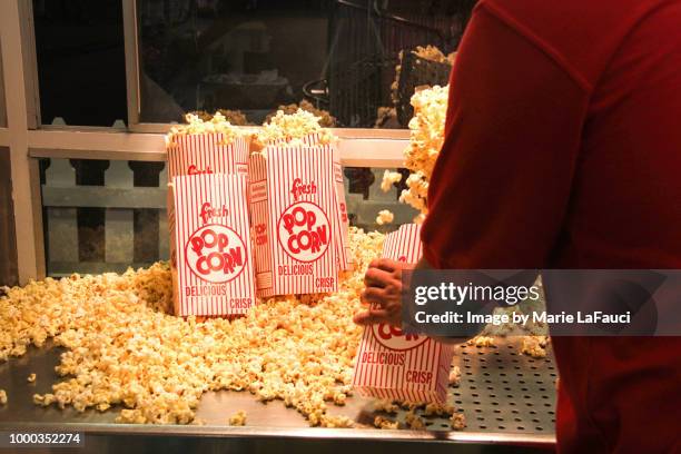 popcorn vendor inside a concession stand - straßenverkäufer stock-fotos und bilder
