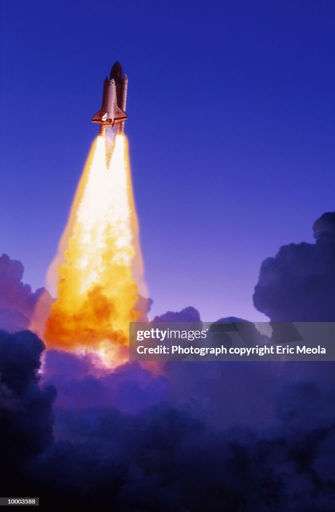 SPACE SHUTTLE BLASTING THRU CLOUDS
