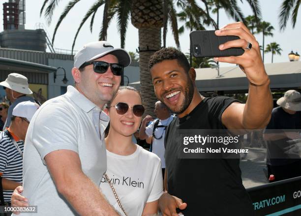 Jeffrey Bowyer-Chapman takes a selfie with fans at "Extra" at Universal Studios Hollywood on July 16, 2018 in Universal City, California.