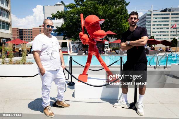 Artist Zevi G stands next to The Art Plug Marcel Katz and a piece he made specifically for the Oakley Pool Party Featuring Deep Eddy Vodka at Capitol...