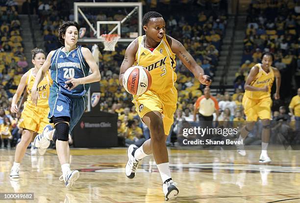 Natasha Lacy of the Tulsa Shock drives the ball up court past Nuria Martinez of the Minnesota Lynx during the WNBA game at the BOK Center on May 15,...