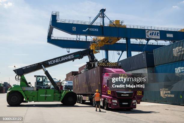 Containers are loaded into the truck in the Duisburg port on July 16, 2018 in Duisburg, Germany. Approximately 25 trains a week use the "Silk Road"...