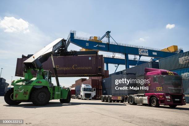 Containers are loaded into the truck in the Duisburg port on July 16, 2018 in Duisburg, Germany. Approximately 25 trains a week use the "Silk Road"...