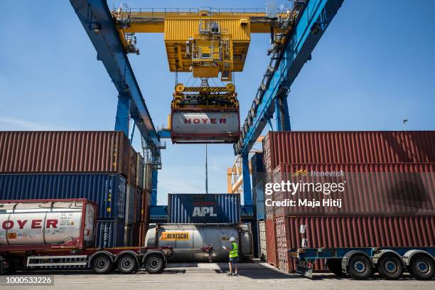 Containers are loaded into the truck in the Duisburg port on July 16, 2018 in Duisburg, Germany. Approximately 25 trains a week use the "Silk Road"...