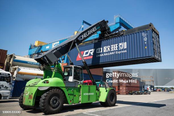 Containers from China are taken between terminals in the Duisburg port on July 16, 2018 in Duisburg, Germany. Approximately 25 trains a week use the...