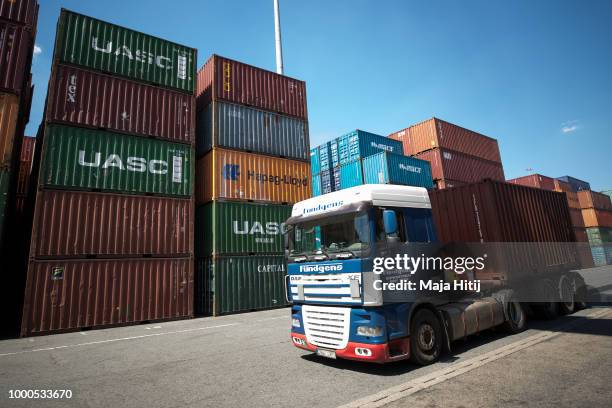 Truck pass by containers at terminal in the Duisburg port on July 16, 2018 in Duisburg, Germany. Approximately 25 trains a week use the "Silk Road"...