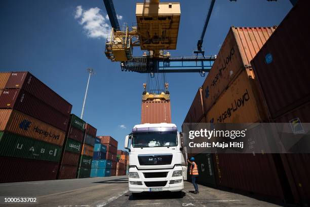 Containers are loaded into truck at terminal in the Duisburg port on July 16, 2018 in Duisburg, Germany. Approximately 25 trains a week use the "Silk...