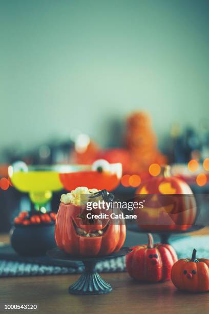 halloween time. vibrant colored drinks with cauldron of popcorn - halloween food stock pictures, royalty-free photos & images