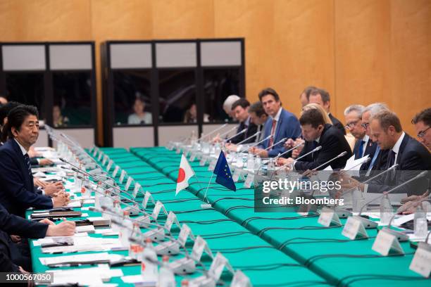 Shinzo Abe, Japan's prime minister, left, attends a meeting with Donald Tusk, president of the European Council, second from right, and Jean-Claude...