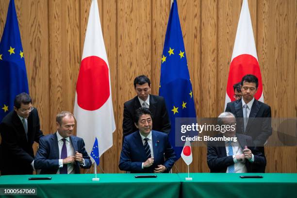 Donald Tusk, president of the European Council, second left, Shinzo Abe, Japan's prime minister, center and Jean-Claude Juncker, president of the...