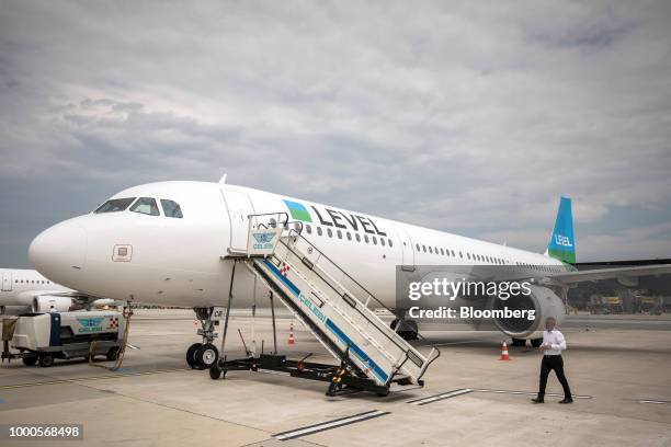 Willie Walsh, chief executive officer of International Consolidated Airlines Group SA , walks towards a passenger aircraft during an event to launch...