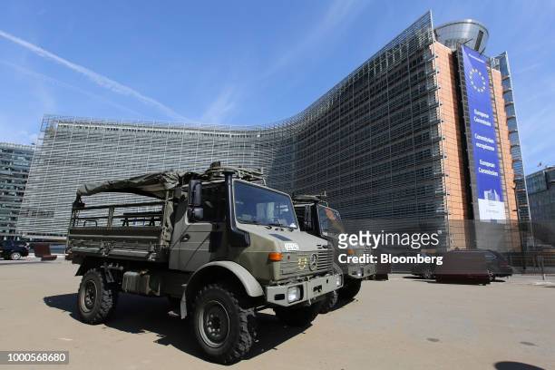 Military vehicles stand parked outside the Berlaymont building, which houses the headquarters of the European Commission, in Brussels, Belgium, on...