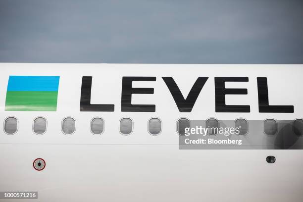 Branding sits on the side of a passenger aircraft during an event to launch the Austrian base for low-cost brand Level, operated by International...