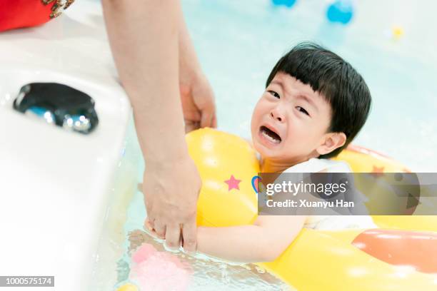 toddler girl crying in the swimming pool - daughter crying stock pictures, royalty-free photos & images