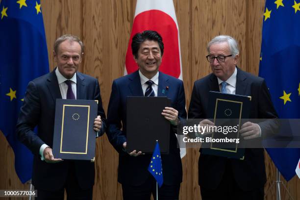 Shinzo Abe, Japan's prime minister, center, Donald Tusk, president of the European Union , left, and Jean-Claude Juncker, president of the European...