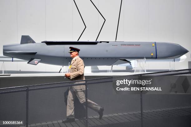 Member of the military walks past a MBDA Storm Shadow/Scalp missile at the Farnborough Airshow, south west of London, on July 17, 2018.
