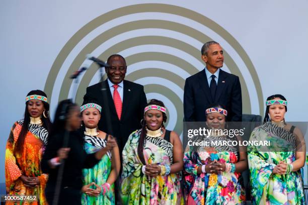 Former US President Barack Obama and South African President Cyril Ramaphosa , stand on stage behind the Soweto Gospel Choir, during the 2018 Nelson...