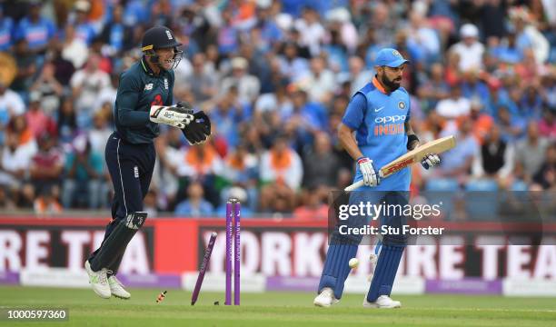 India batsman Virat Kohli reacts as Jos Buttler celebrates after Rashid had bowled Kohli for 71 runs during 3rd ODI Royal London One Day match...