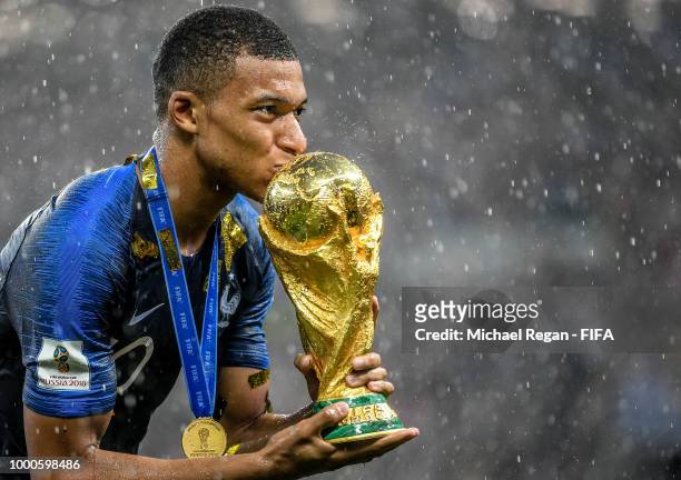Kylian Mbappe of France kisses the World Cup trophy following the 2018 FIFA World Cup Final between France and Croatia at Luzhniki Stadium on July...