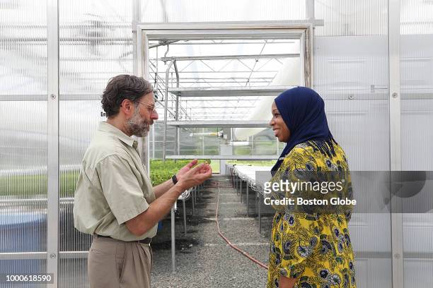 Tahirah Amatul-Wadud, right, speaks with Fred Rose, founder of Wellspring Harvest Greenhouse, in Springfield, MA on July 3, 2018. Amatul-Wadud is a...