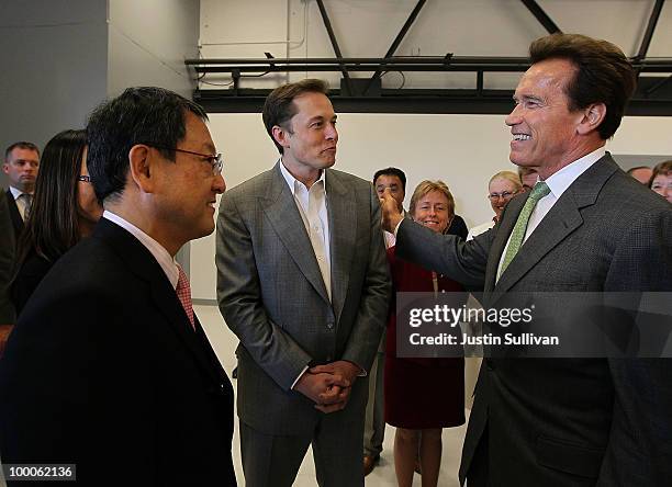 Toyota CEO Akio Toyoda, Tesla Motors CEO Elon Musk and California governor Arnold Schwarzenegger chat before a news conference at Tesla Motors...