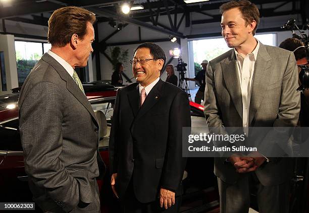 California governor Arnold Schwarzenegger, Toyota CEO Akio Toyoda and Tesla Motors CEO Elon Musk chat before a news conference at Tesla Motors...