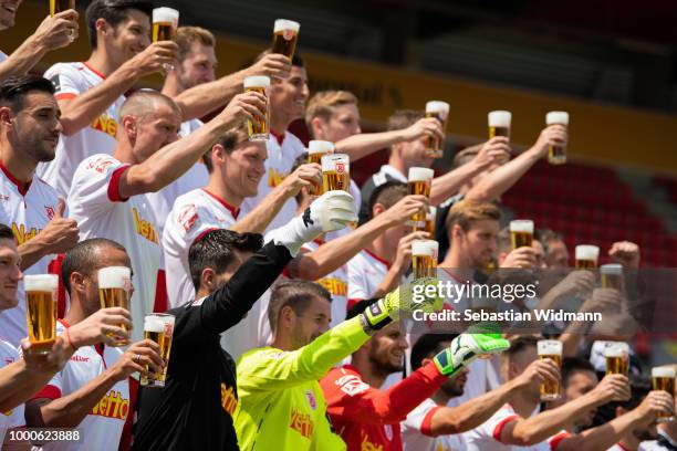 Players of Jahn Regensburg pose with beer mugs during the team presentation at Continental Arena on July 17, 2018 in Regensburg, Germany.