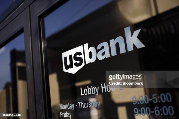 Signage is displayed on the door of a US Bancorp branch in Louisville, Kentucky, U.S., on Thursday, July 12, 2018. US Bancorp is scheduled to release...