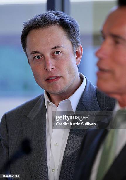 Tesla Motors CEO Elon Musk look on as California governor Arnold Schwarzenegger speaks during a news conference at Tesla Motors headquarters May 20,...
