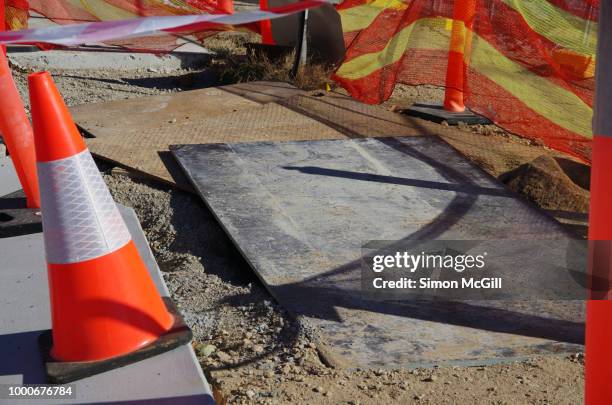traffic cones, construction barrier mesh and plastic cordon tape surround construction work - barrikade stock-fotos und bilder