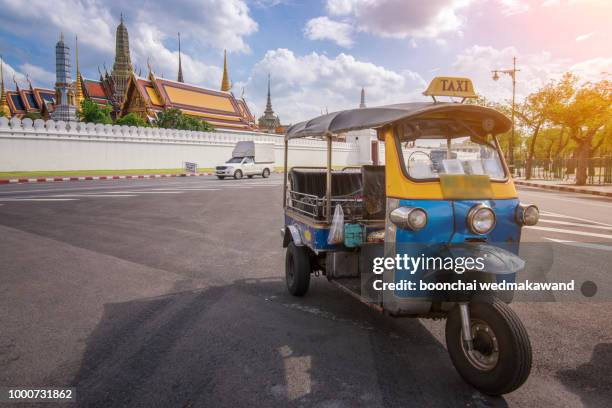 tuk tuk is parking in front of wat phra kaeo or grand palace, bangkok, thailand. - tuk tuk stock-fotos und bilder