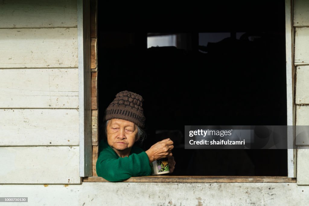 Old lady from Penan's tribe enjoying evening moment at Bario.