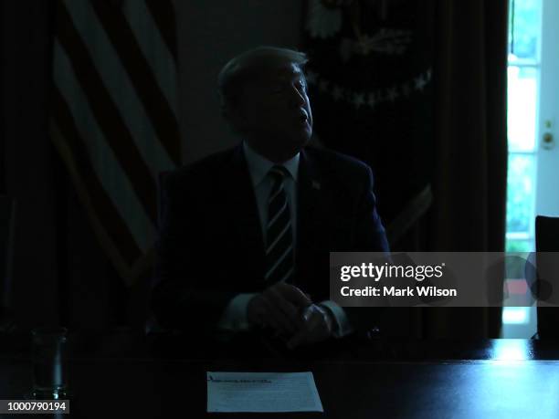 The lights temporarily go out in the Cabinet Room as U.S. President Donald Trump talks about his meeting with Russian President Vladimir Putin,...